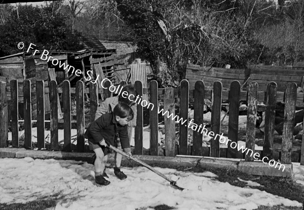 CHILD PLAYING WITH SHOVEL